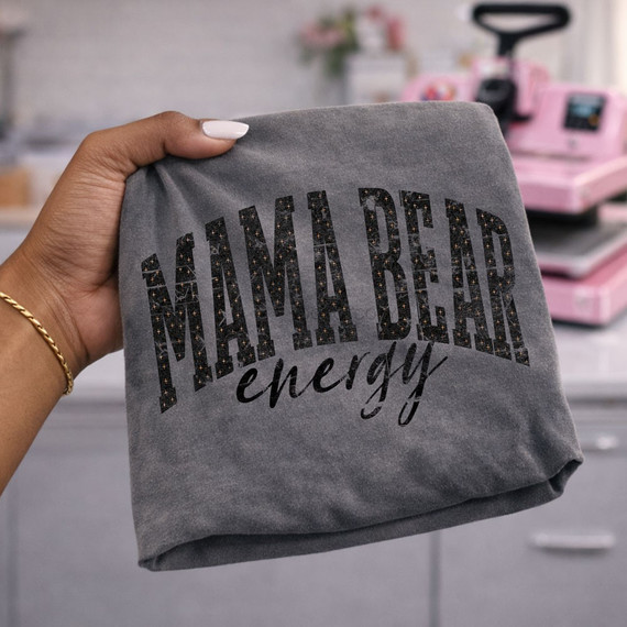 Mama Bear Energy DTF transfer in bold black arched lettering with sparkly speckled texture and script accent, shown on a heather gray shirt