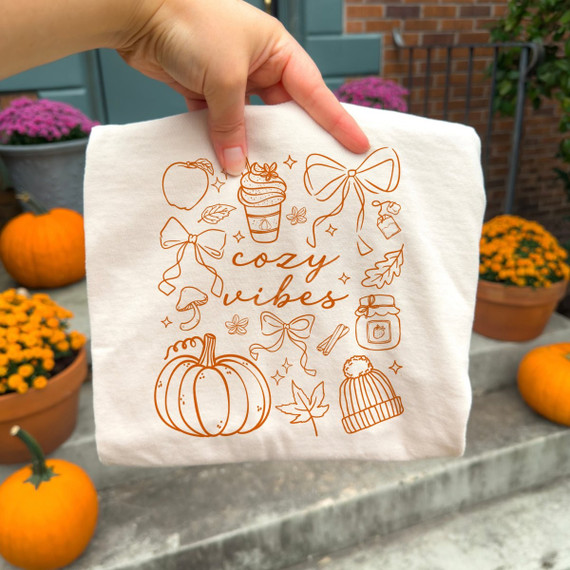 Cozy Vibes fall doodle DTF transfer in single-color line art with pumpkin, coquette bows, coffee cup, beanie, and autumn leaves