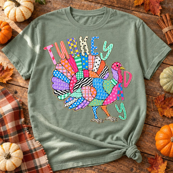 Turkey Day DTF transfer with colorful patchwork-patterned turkey and matching patterned bubble letters Shown on a Sage t-shirt.