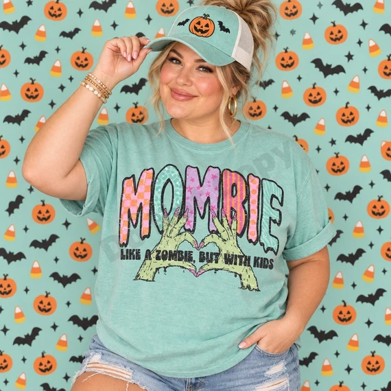 MOMBIE Halloween DTF transfer with patterned varsity letters, green zombie hands forming a heart, and tagline Like A Zombie But With Kids Shown on a Island Reef t-shirt.