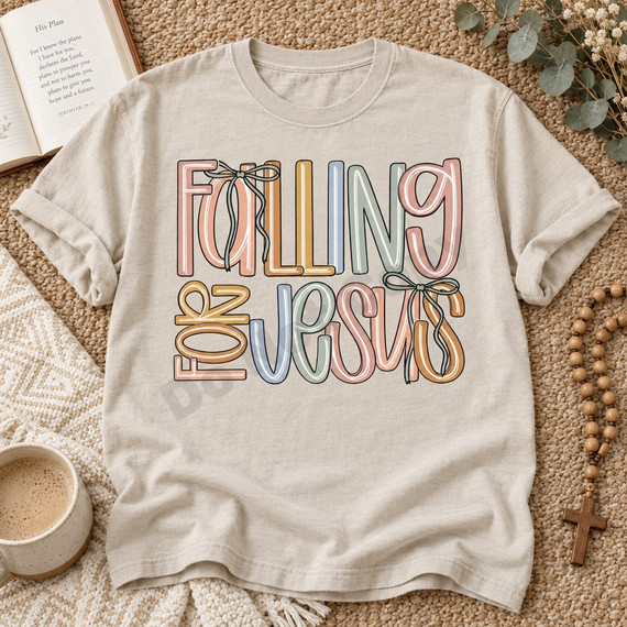 Falling For Jesus retro bubble-letter DTF transfer in pastel multicolor with sage green bow accents on a tan t-shirt Shown on a Hemp t-shirt.