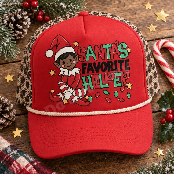 Santa's Favorite Helper DTF transfer with cheerful elf character in Santa hat, gold stars, and Christmas lights design Shown on a Red foam front, cream rope, leopard mesh back trucker hat.