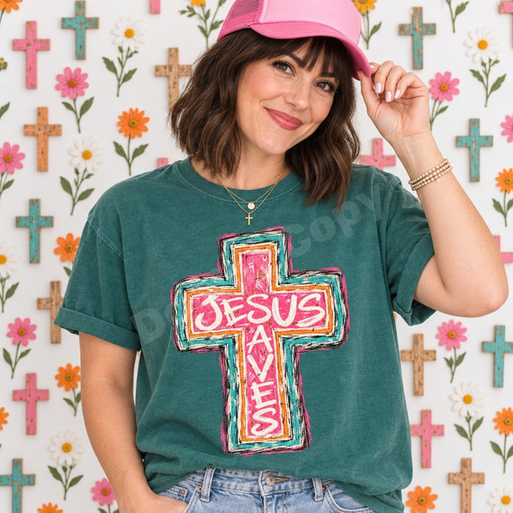 JESUS SAVES cross DTF transfer in distressed pink, orange, and teal boho style with black outline Shown on a Island Green t-shirt.