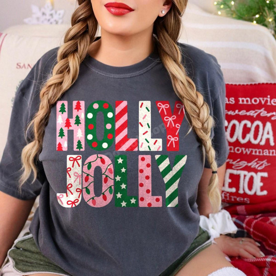 Holly Jolly Christmas DTF Transfer | Patterned Holiday Letters Design, festive red and green “HOLLY JOLLY” lettering with Christmas trees, ornaments, bows, stars, and stripes printed on a charcoal T-shirt.