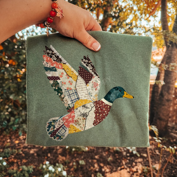 Flying mallard duck DTF transfer in faux patchwork quilt print design with floral and plaid fabric patterns