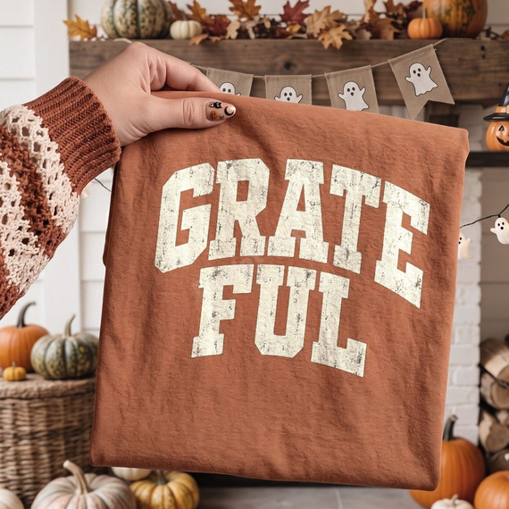 Grateful distressed collegiate letters DTF transfer in cream on a rust colored shirt, fall and Thanksgiving design