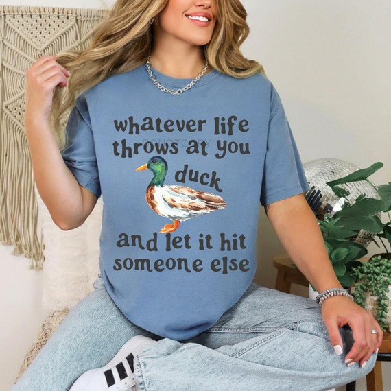 Whatever Life Throws At You Duck DTF Transfer | Funny Watercolor Duck Design, humorous watercolor mallard duck with the phrase “Whatever life throws at you, duck and let it hit someone else” displayed on a blue T-shirt.