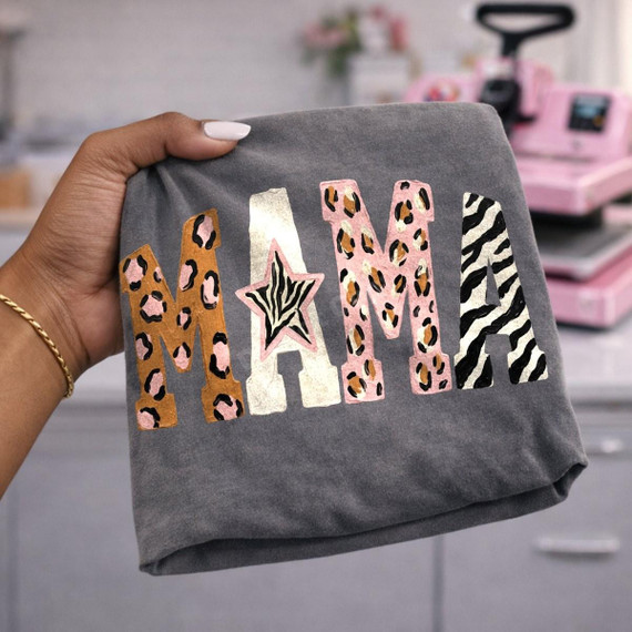 Mama Animal Print DTF Transfer | Leopard & Zebra Mixed Print Design, close-up of the colorful leopard and zebra print “MAMA” design with a star on a gray shirt held up for display
