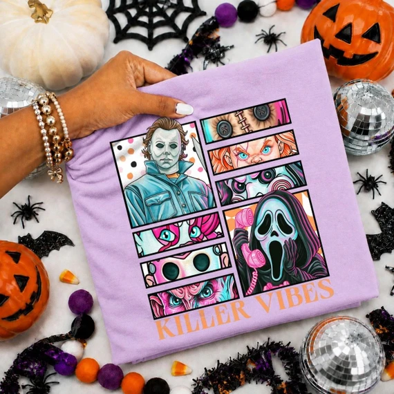 Killer Vibes Horror Icons DTF Transfer | Retro Pastel Halloween Design, colorful retro comic panels featuring iconic horror characters on a lavender shirt, displayed with Halloween decorations