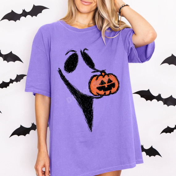 Hand-sketched ghost face DTF transfer with one eye replaced by a jack-o-lantern, shown in black scribble line art on a purple shirt