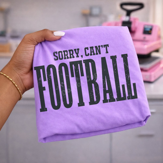 Sorry, Can't Football DTF transfer with bold distressed black lettering on a purple shirt