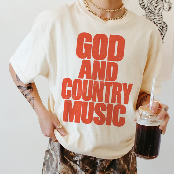 God and Country Music DTF transfer in bold distressed orange retro lettering on a cream shirt