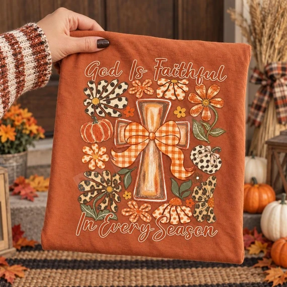 God Is Faithful In Every Season DTF Transfer | Fall Cross Faith Design, autumn faith-themed cross surrounded by fall flowers, pumpkins, and gingham details on a rust-colored shirt