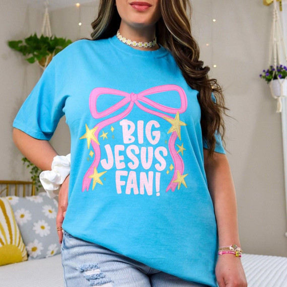 Big Jesus Fan DTF Transfer | Retro Pink Bow Faith Design, retro pink bow and yellow star faith graphic with bold white “Big Jesus Fan!” lettering displayed on a bright blue T-shirt