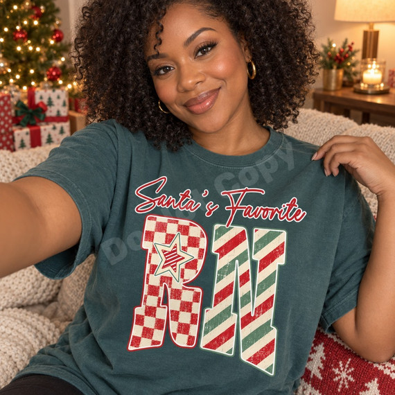 Santa's Favorite RN Christmas DTF transfer with red script lettering, checkerboard R with striped star, and candy-cane striped N Shown on a Blue Spruce t-shirt.
