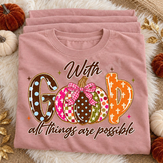 With God all things are possible DTF transfer featuring patterned block letters and a polka-dot pumpkin with pink gingham bow Shown on a Blossom t-shirt.