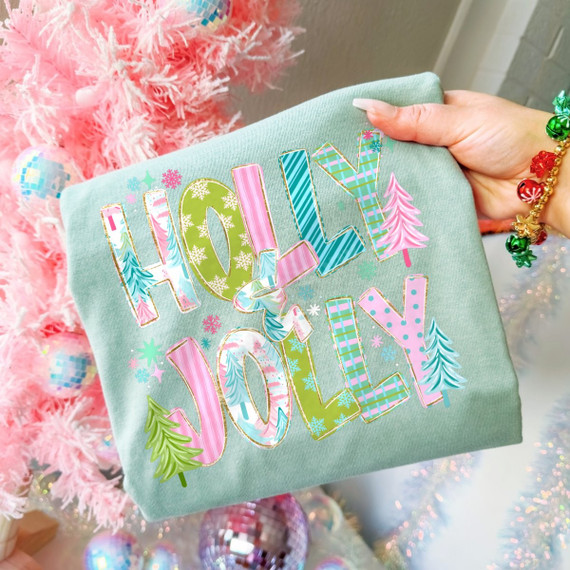 Holly & Jolly Christmas DTF transfer with pastel patterned bubble letters, gold glitter-style outlines, and mini Christmas trees on a sage green shirt