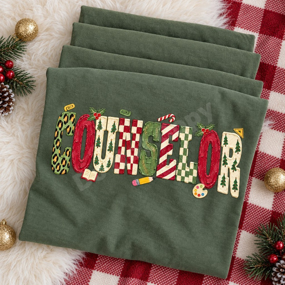 COUNSELOR Christmas word art DTF transfer in painterly block letters with leopard print, candy cane stripes, checkerboard and tree patterns, accented with holly, a pencil, an open book and a paint palette Shown on a Moss t-shirt.