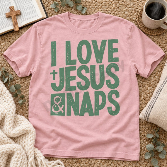 I Love Jesus & Naps DTF transfer in bold distressed sage green block lettering with cross and ampersand accents Shown on a Rose Quartz t-shirt.