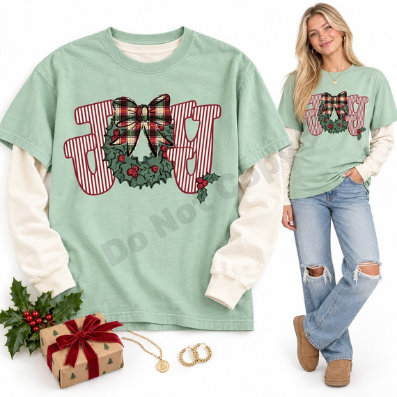 JOY DTF transfer with red-and-white striped block letters, a holly and berry wreath, and a black-outlined plaid bow Shown on a Chalky Mint t-shirt.