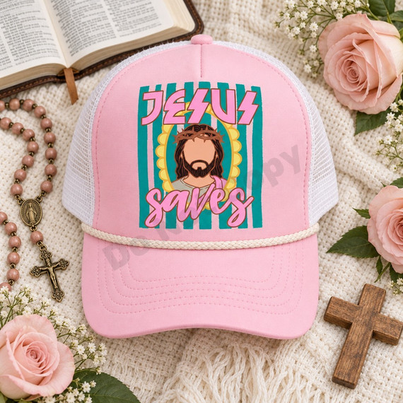 Jesus Saves DTF transfer featuring an illustrated portrait of Jesus with a crown of thorns in a yellow scalloped halo frame, pink graffiti lettering, and teal striped background, shown on a pink trucker hat Shown on a Pink foam front panel with ivory rope and white mesh back trucker hat.