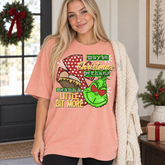 Maybe Christmas Perhaps DTF transfer with red polka-dot number one, nativity baby-in-a-manger scene, and lovestruck green Grinch face with heart-shaped eyes and snowflakes Shown on a Peachy t-shirt.