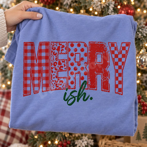Merry-ish Christmas DTF transfer with distressed red patterned lettering in buffalo plaid, leopard, polka dot, and checkerboard, paired with dark green brush-script ish. text Shown on a Periwinkle t-shirt.