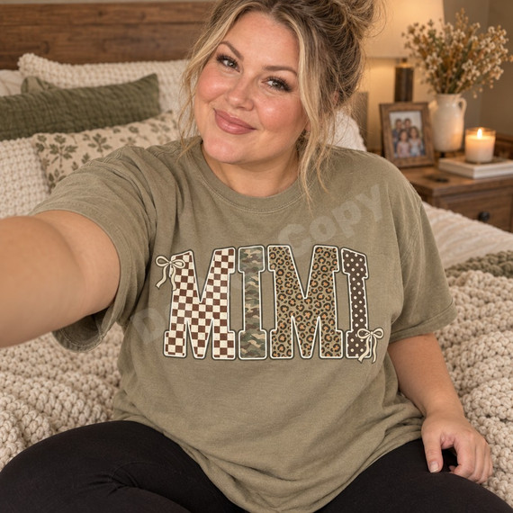 MIMI block-letter DTF transfer with checkerboard, camo, leopard, and polka dot patterns, white outlines, and cream bow accents Shown on a Khaki t-shirt.