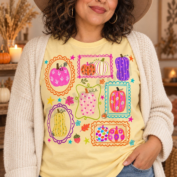 Colorful whimsical pumpkin DTF transfer with polka-dot, striped, heart-print, and floral pumpkins in scalloped frames with stars, leaves, and acorns Shown on a Butter t-shirt.