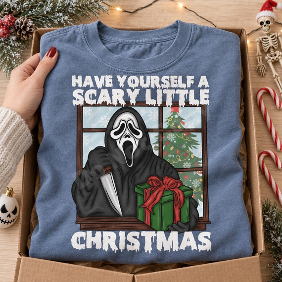 Have Yourself a Scary Little Christmas DTF transfer with Ghostface-style killer holding a knife and wrapped present at a snowy window with Christmas tree Shown on a Chambray t-shirt.