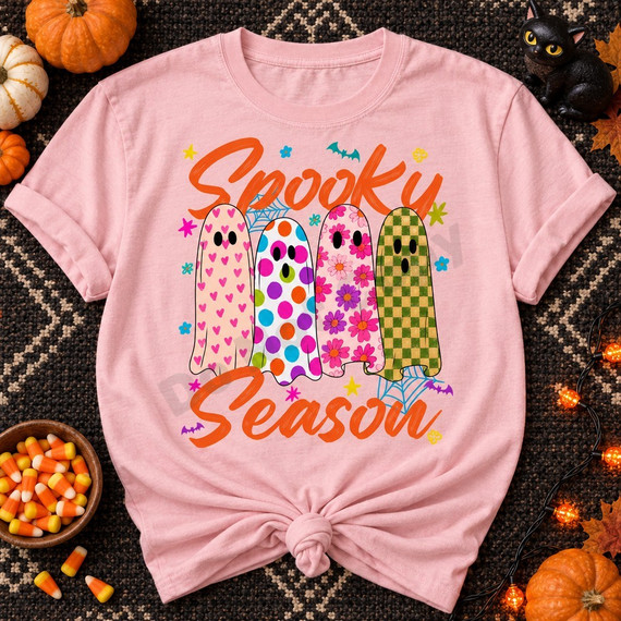 Spooky Season DTF transfer featuring four patterned ghosts in pink hearts, rainbow polka dots, floral, and checkerboard designs with orange script lettering and Halloween doodles Shown on a Blossom t-shirt.
