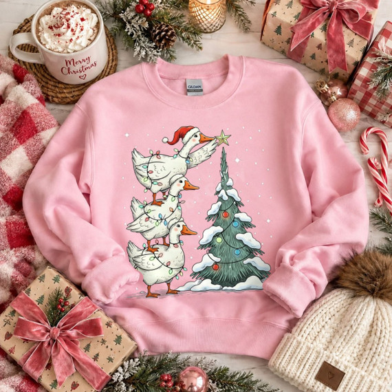 Three stacked geese wrapped in string lights decorating a snowy Christmas tree, one wearing a Santa hat, DTF transfer design