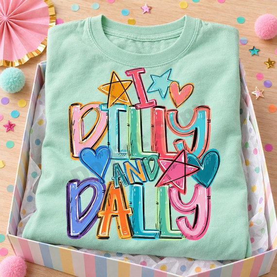 I Dilly and Dally DTF transfer in rainbow bubble lettering with hand-doodled stars and hearts in pastel and bright colors Shown on a Chalky Mint t-shirt.
