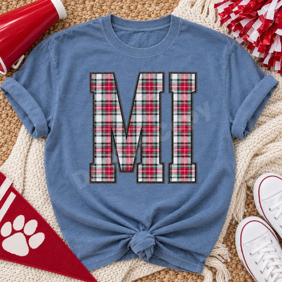 MI varsity letters DTF transfer in red, green, black and white tartan plaid with gray outline on a blue t-shirt Shown on a Chambray t-shirt.