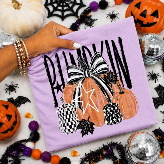 Pumpkin DTF transfer with brush-script lettering, a black and white checkered pumpkin, star-patterned pumpkin, bow, and fall leaves