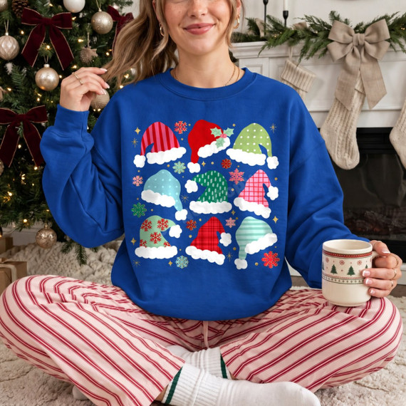 Christmas DTF transfer with a grid of nine patterned Santa hats in stripes, polka dots, plaid, and florals surrounded by snowflakes
