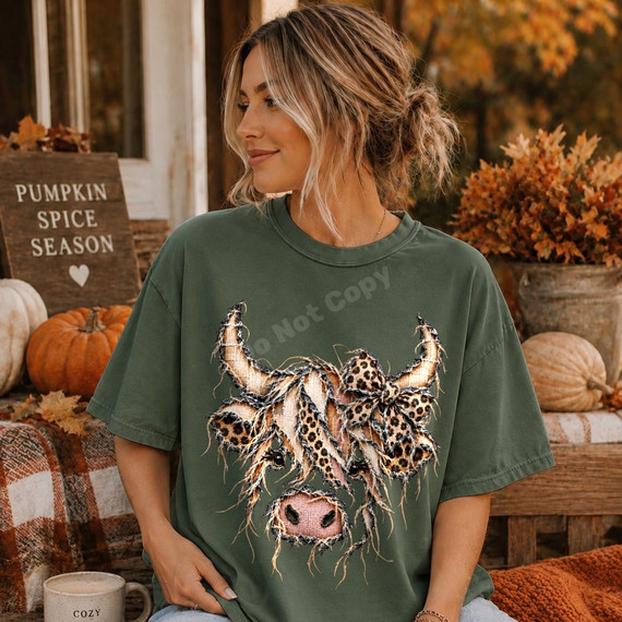Highland cow DTF transfer with leopard print bow and frayed fabric-style patchwork texture on a sage green shirt