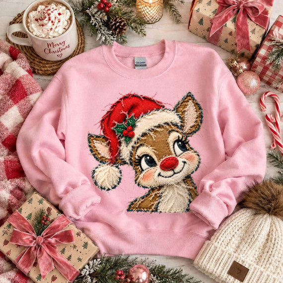 Reindeer in Santa hat Christmas DTF transfer with faux-embroidery stitched style on a pink sweatshirt