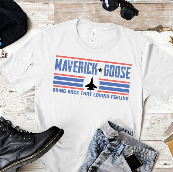 Bring Back That Loving Feeling Sublimation Transfer, sport-themed T-shirt with Maverick Goose fighter jet graphic and patriotic color scheme, laid out with accessories and jeans.