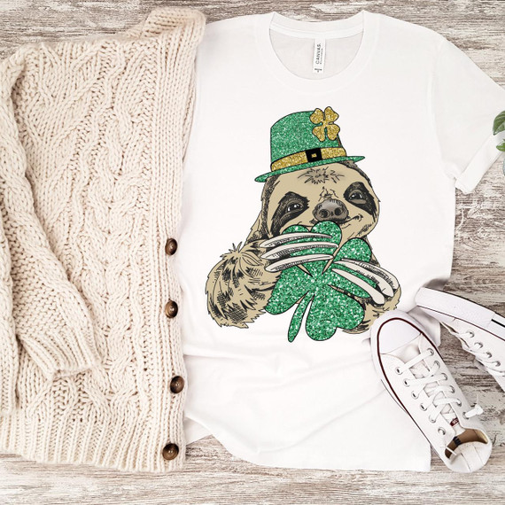 Lucky Sloth Clover glitter St. Patrick's Day Sublimation Transfer, a graphic of a cute sloth wearing a green glitter St. Patrick's Day hat and holding a green glitter shamrock, perfect for holiday-themed apparel or accessories.