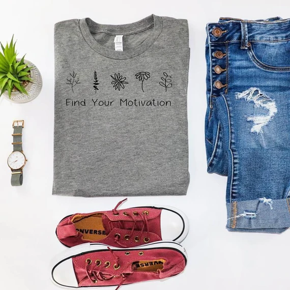 Find Your Motivation Screen Print Transfer, a grey t-shirt with black flower and plant illustrations and the phrase 'Find Your Motivation' printed on it.