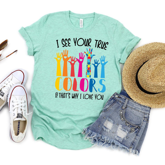 I See Your True Colors Autism Screen Print Heat Transfer, colorful t-shirt with raised hands in various colors and patterns, message of love and support for autism awareness.