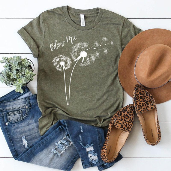 Blow Me Dandelion WHITE Screen Print Transfer, a white graphic print of dandelions on an olive green T-shirt.
