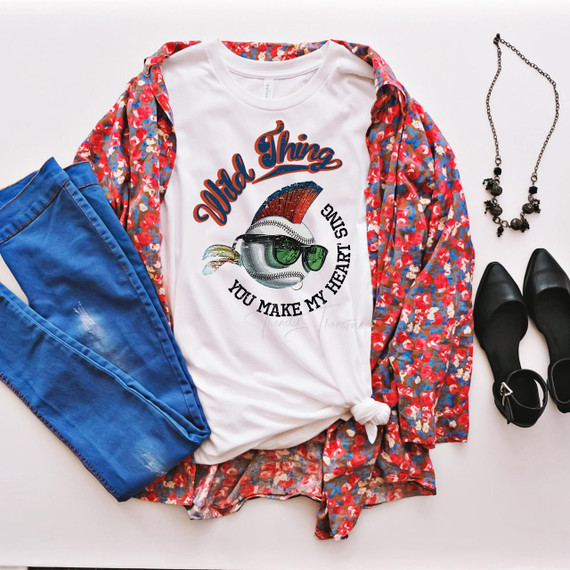 Wild thing you make my heart sing Baseball Sublimation Transfer, display of casual fashion accessories and clothing with a baseball-themed T-shirt, blue jeans, black shoes, necklace, and a floral kimono.