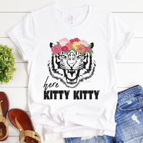 Here Kitty Kitty Sublimation Transfer, white T-shirt with a black tiger face design decorated with a colorful floral crown and the text 'here KITTY KITTY' printed below.