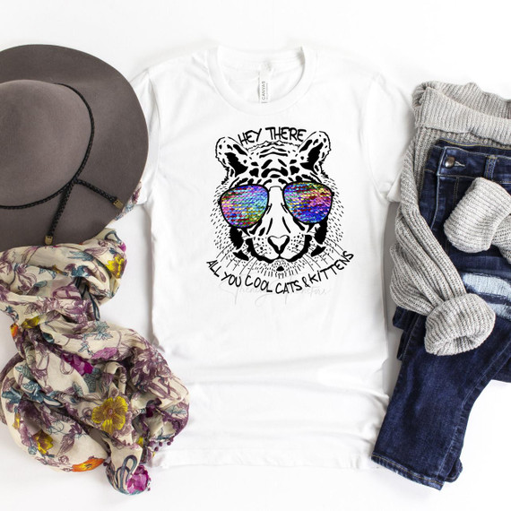 Tiger King Fan Art T-Shirt, a white sublimation transfer shirt featuring a line art illustration of a tiger wearing colorful sequin sunglasses with the text 'Hey there all you cool cats and kittens'.