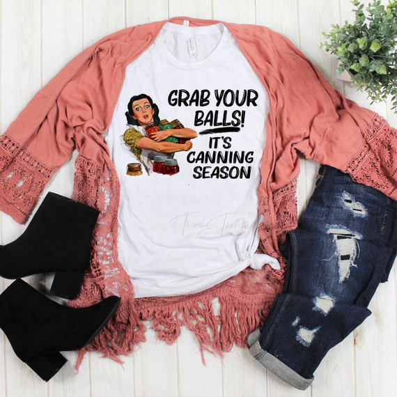Grab your Balls, vintage retro sublimation transfer T-shirt with a woman holding jars of canned food and text, canning season theme, flat lay fashion concept.