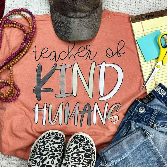 Teacher of Kind Humans Screen Print Heat Transfer, a clothing design illustrating the phrase 'teacher of KIND HUMANS' on a pink t-shirt.