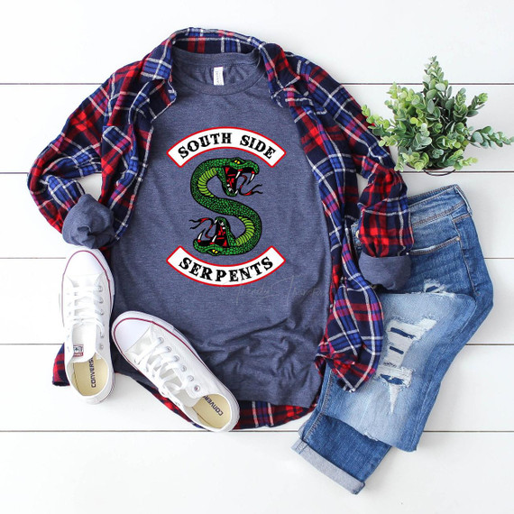 South Side Serpents FINAL STOCK Screen Print Transfer - Graphic T-shirt with a coiled green serpent and bold lettering, casual outfit laid out with jeans, sneakers, a plaid shirt, and a potted plant.