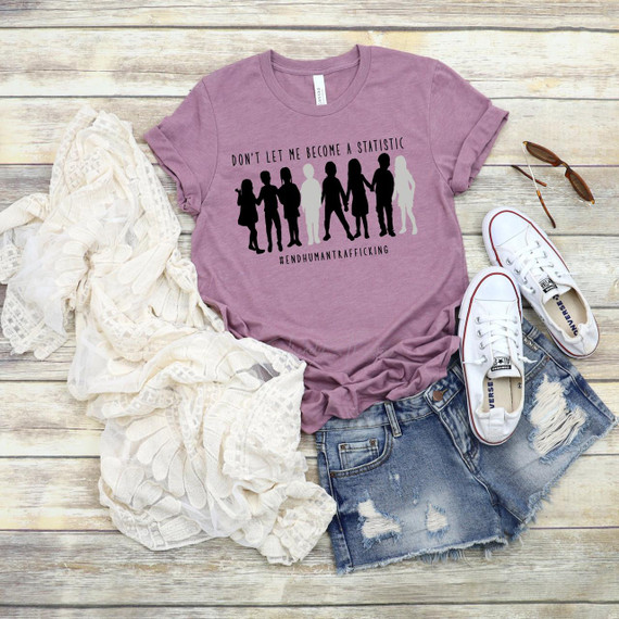Don't Let Me Become A Statistic Screen Print Transfer, a purple T-shirt with a graphic design warning against human trafficking and featuring silhouettes of people holding hands.